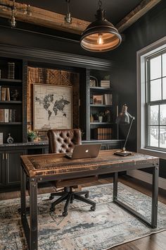 a desk with a laptop on top of it in front of a bookcase and window