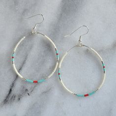 "Do you make these in silver?" After years of fielding that question about our best-selling Big Beaded Hoops, the answer is finally YES! Here you'll find all the classic styles — yes, even 'The Ones' — just reimagined with silver beads in place of gold. These dangle hoop earrings are the pieces you'll grab every day. beaded hoops with tiny glass seed beads silver-plated stainless steel ear wire hooks and beading wire lead-free and nickel-free comes with plastic earring back for security availabl Everyday White Teardrop Hoop Earrings, White Teardrop Hoop Earrings Nickel Free, Silver Metal Beaded Hoop Earrings, Green Nickel-free Small Hoop Beaded Earrings, Nickel-free Metal Hoop Beaded Earrings, Bohemian Nickel-free Beaded Hoop Earrings, Turquoise Nickel-free Small Hoop Beaded Earrings, Seed Bead Hoop Earrings, Bead Hoop Earrings