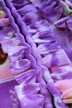 a purple blanket with pink and white designs on it