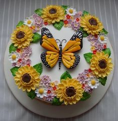 a cake decorated with sunflowers and butterflies