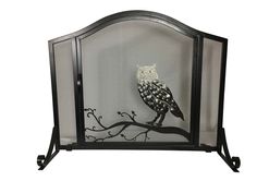 an owl sitting on top of a tree branch in front of a screen with black iron frame