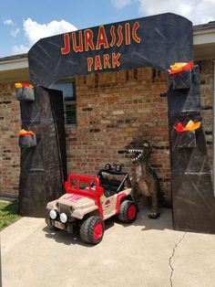 a toy jeep parked in front of a park entrance