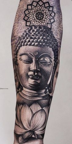 an arm with a buddha tattoo on it