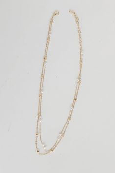 The Brooke Gold Pearl Layered Chain Necklace is the simplest way to make any look even more darling! This trendy necklace features two layers of gold chains with pearls. Style the Brooke Necklace with any outfit to instantly upgrade your look! Gold Plated Layered Pearls Lobster Clasp with Extender Layer 1 | Length 7.5" Layer 2 | Length 7" Extender | Length 3" Gold Pearl Necklace For Layering, Dainty Double Strand Pearl Chain Layered Necklace, Gold Double Strand Pearl Necklace In Dainty Style, Gold Double Strand Pearl Necklace, Dainty, Layering Pearl Necklace With Chain, Gold Double Strand Pearl Necklace For Layering, White Double Strand Pearl Chain Layered Necklace, Gold Double Strand Pearl Necklace With Adjustable Chain, Gold Double Strand Necklace For Layering