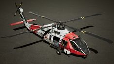 a red and white helicopter sitting on top of a tarmac