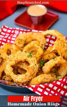 air fryer onion rings on a red and white checkered tablecloth