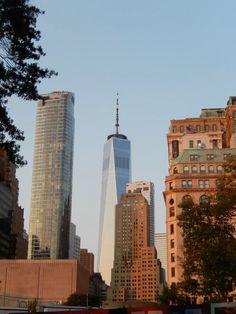 there are many buildings in the city with tall skyscrapers on each side and one large building at the far end