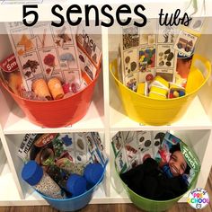 four buckets filled with different types of toys and books on top of a shelf