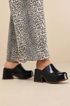 Let everyone know your style is one to watch with the Melissa Mia Black and Brown Platform Mules! Sleek, seamless rubber shapes these instantly iconic mules that have an almond-shaped toe and a flexible, clog-inspired upper. 1.25"" toe platform and chunky block heel boast a cool, brown-toned border to complete the look. Easy, slide-on design. Available in whole sizes only. 3. 5" block heel. Cushioned insole. Rubber sole has nonskid markings. Man Made Materials. Imported. Lulus | Mia Black and Br