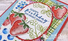 a close up of a greeting card with strawberries and flowers on the bottom corner