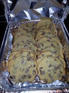 chocolate chip cookies sitting on top of aluminum foil