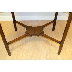 a wooden table sitting on top of a hard wood floor