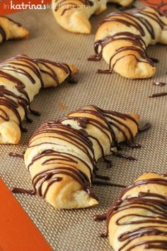 chocolate covered croissants on a baking sheet