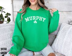 Introducing our Custom Name Sweatshirt - a personalized masterpiece designed for those who wish to embrace their Irish heritage in style. Whether you're donning it for a festive family gathering or presenting it as a heartwarming gift, our Custom Name Sweatshirt is a symbol of pride, warmth, and a touch of the Emerald Isle. Personalize your style and make a statement this St. Patrick's Day with this one-of-a-kind sweatshirt. We use professional quality DGT printing on all our apparel. Direct-to-garment, or DTG, is a high quality printing method that sprays ink directly onto the garment so there is no peeling or cracking. Production Time: 1-5 days Shipping Time: 2-5 days Description: Gildan 18000 Unisex Sweatshirt Medium-heavy fabric Runs true to size (size up for an oversized fit) 50% cott Stitch Sweatshirt, Name Sweatshirt, Green Lips, Bar Crawl, Colorful Sweatshirt, Irish Pride, Shamrock Shirt, Irish Heritage, Lips Print