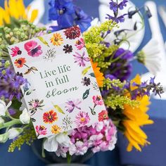 a card that says live life in full bloom surrounded by colorful flowers and daisies