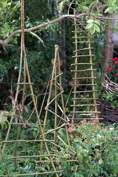 several wooden ladders sitting in the middle of a garden