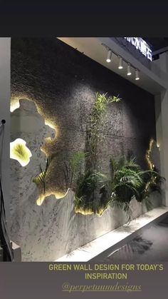 a wall with plants and lights on it