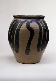 a black and white vase sitting on top of a table