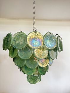 a chandelier made out of glass plates hanging from a ceiling in a room