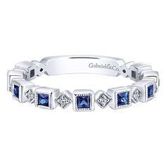 a white gold band with blue sapphire and diamonds