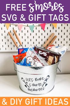 a bucket filled with candy and other items on top of a white table next to a sign