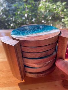 a stack of wooden coasters sitting on top of a table