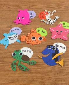 several different types of sea animals on a wooden table with words written in the middle