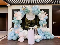 a balloon arch decorated with blue, white and silver balloons in the shape of rabbits