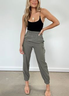 Our Can't Stop Cargo Joggers offer a luxuriously sophisticated style that is perfect for any occasion. Featuring a stretchy elastic waistband to provide optimal comfort and a high waisted fit for a versatile look, these joggers are designed for ultimate softness while still providing a neutral and elegant aesthetic with their cargo pocket details. Enjoy premium quality and comfort with the Can't Stop Cargo Joggers. 95% Polyester 5% Spandex Hand wash cold. High Rise Athleisure Bottoms With Elastic Waistband, Stretch Cargo Style Tapered Leg Bottoms, Stretch Tapered Leg Cargo Bottoms, Trendy Stretch Joggers With Elastic Waistband, Stretch Joggers For Workwear, High Waist Stretch Joggers Casual Style, Trendy High Waist Stretch Joggers, Chic Stretch Bottoms With Banded Waist, Stretch Cargo Pants With Elastic Waistband For Workwear