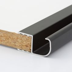 an image of a black and white door frame with cork on the outside side,