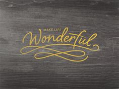 the words make life wonderful written in gold on a wood background with handwritten lettering