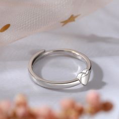 Dainty and delicate, this heart ring makes a little lovely gift for loved one or yourself. Heart is one of the most popular motifs in jewelry that often related with love. Crafted in sterling silver, this band features one heart for an effortless look.This band is a beautiful reminder of your timeless romance.Weight: 2 gWidth: 2.7 mmHeight: 2.3 mmThickness: 1.4 mmMaterial: 925 SilverPlating Color: Silver Dainty Open Heart Ring As Gift, Adjustable Heart Ring For Promise On Mother's Day, Adjustable Heart Ring For Promise And Mother's Day, Dainty White Gold Heart Ring For Promise, Minimalist Jewelry For Valentine's Day Promise, Valentine's Day Couples Jewelry In White Gold, Valentine's Day Couples White Gold Jewelry, Valentine's Day Couples' White Gold Jewelry, Delicate Heart Charm Ring As Gift