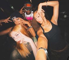 four young women posing for the camera with their hands on their hipss and one holding her head