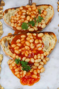 two pieces of bread with baked beans on them