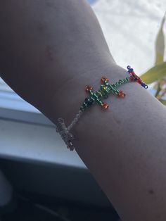 a person's arm with a beaded bracelet on it