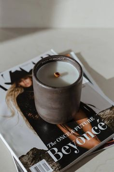 a magazine with a candle sitting on top of it