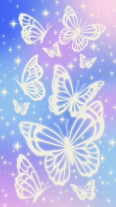 a group of white butterflies flying through the air with stars in the sky behind them