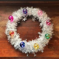 a wreath made out of tinsel and christmas ornaments