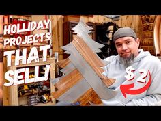 a man holding up a large wooden christmas tree with the words holiday projects that sell on it