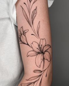 a black and white flower tattoo on the arm