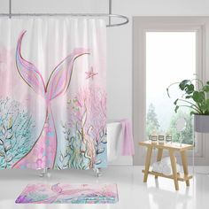 a bathroom with a pink and blue shower curtain, white bath rug and potted plant