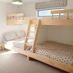 bunk beds in a bedroom with two sets of ladders on the top and bottom