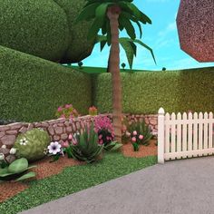 a white picket fence sitting next to a lush green field filled with flowers and plants