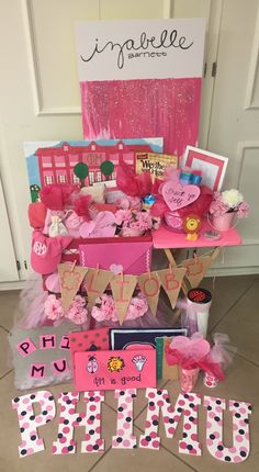 a display with pink and white decorations on it's sides, including letters that spell out the word prim