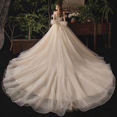 a woman in a wedding dress standing next to a piano