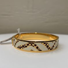 Mahogany Signature C Pattern Against White Stripes In A Zebra Pattern On This Gold Tone Enamel Bangle From Coach. It Has Two Buttons On The Exterior, One Of Which Shows Some Spots From Age, As This Has Never Been Worn. The Interior Is Stamped Twice With Coach Logos And One That Reads China, Where It Was Made, As Shown In The Photos. Matching Ring Is Also For Sale. Thrifting Jewelry, Coach Ring, Everyday Workouts, Coach Fashion, Black Bangle, Coach Jewelry, Zebra Pattern, Enamel Bangle, Matching Ring