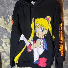 New W/O Price Tag Is An Overstock Outlet (Has Backline Going Thru Cloth Label Name To Prevent Store Return) Authentic Sailor Moon Hoodie - Black - 60% Cotton, 40% Polyester - Hoodie - Size Medium; Chest 23, Length 27 Black Cartoon Print Hoodie Top, Casual Anime Print Hooded Top, Casual Hooded Top With Anime Print, Black Harajuku Hoodie Top, Black Hooded Top With Cartoon Print, Black Harajuku Style Hoodie Top, Casual Graphic Print Hoodie For Cosplay, Trendy Black Hoodie With Cartoon Print, Hooded Character Print Top For Streetwear