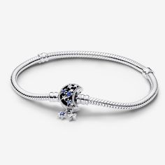 Bring a celestial touch to your style with the Pandora Moments Sparkling Moon Clasp Snake Chain Bracelet. With a clasp shaped like a crescent moon, this sterling silver snake chain bracelet has a "Dream big" engraving on the clasp's back. The intricate clasp features cut-out stars and circles set with six blue man-made crystals and five clear cubic zirconia, as well as microbeading and imprinted detailing. Two asymmetrical stars set with sparkling stones dangle from the clasp, adding a dash of m Sterling Silver Celestial Bracelet, Celestial Silver Bracelet, Celestial Silver Bracelets With Moon Phase, Metal Moon Charm Bracelet Jewelry, Celestial Silver Moon Phase Bracelets, Celestial Sterling Silver Bracelets, Silver Metal Bracelet With Moon Charm, Silver Metal Bracelets With Moon Charm, Elegant Silver Bracelets With Moon Phase