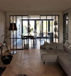 a living room filled with furniture next to a dining table and glass doors that open onto a patio