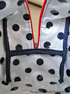 a polka dot bag with zippers on it